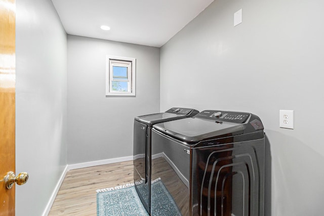 5468 S Custer Rd, Custer, MI 49405 - laundry area featuring washer and dryer and wood finished floors