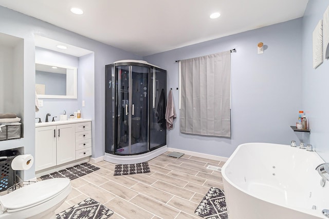 5468 S Custer Rd, Custer, MI 49405 - full bathroom featuring a whirlpool tub, vanity, recessed lighting, a stall shower, and wood finish floors