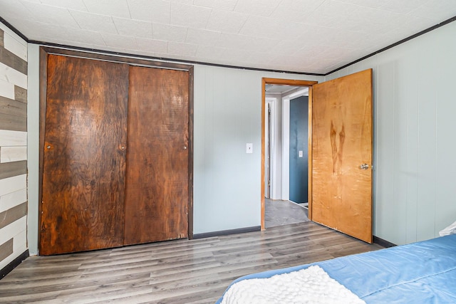 5468 S Custer Rd, Custer, MI 49405 - bedroom with a closet, wood finished floors, and wooden walls