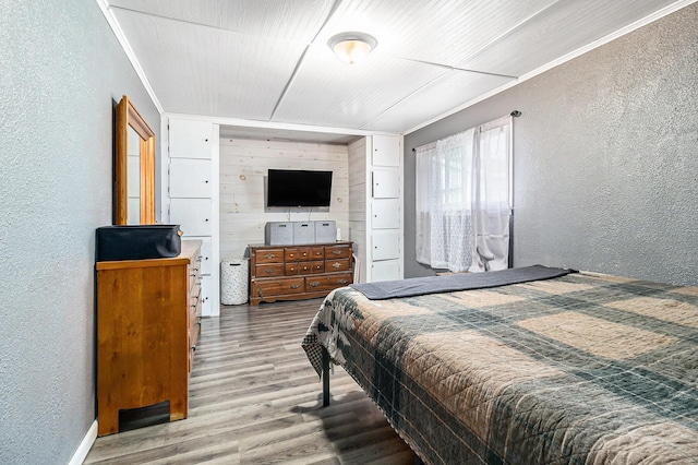 5468 S Custer Rd, Custer, MI 49405 - bedroom with a textured wall, wood finished floors, and crown molding