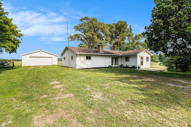 5468 S Custer Rd, Custer, MI 49405 - back of property with a garage, a chimney, an outdoor structure, and a yard