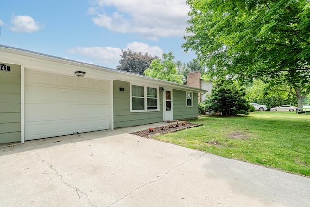 8741 Meadow Ln, Berrien Springs, MI 49103 - ranch-style home featuring concrete driveway, a front lawn, a garage, and a chimney