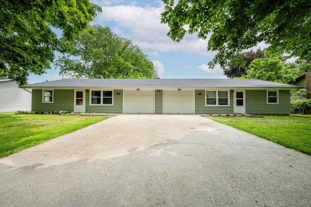 8741 Meadow Ln, Berrien Springs, MI 49103 - ranch-style home featuring a garage, driveway, a front yard, and roof with shingles