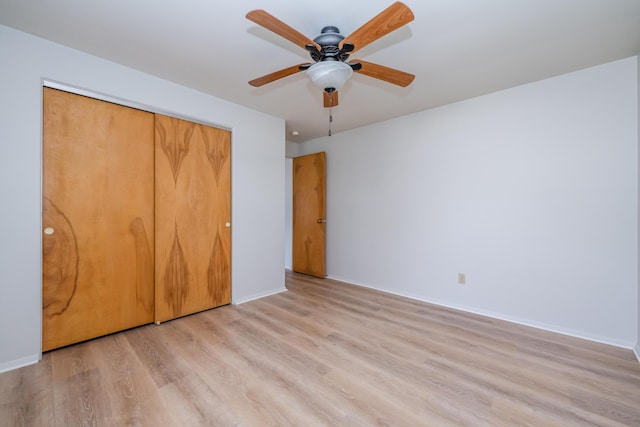 8741 Meadow Ln, Berrien Springs, MI 49103 - unfurnished bedroom featuring light wood-type flooring, a closet, and a ceiling fan