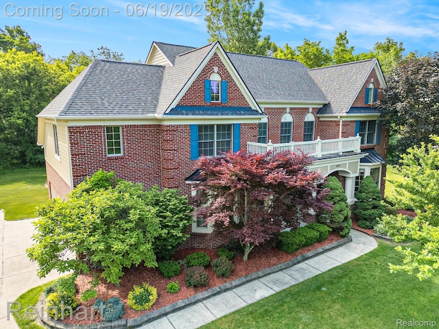 2032 Cameo Ct, Canton, MI 48187 - view of front facade featuring a balcony, brick siding, a front yard, and roof with shingles