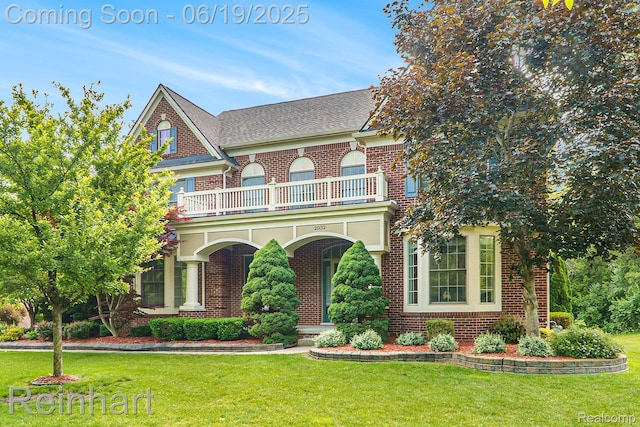 2032 Cameo Ct, Canton, MI 48187 - colonial-style house with a balcony, brick siding, a front yard, and roof with shingles