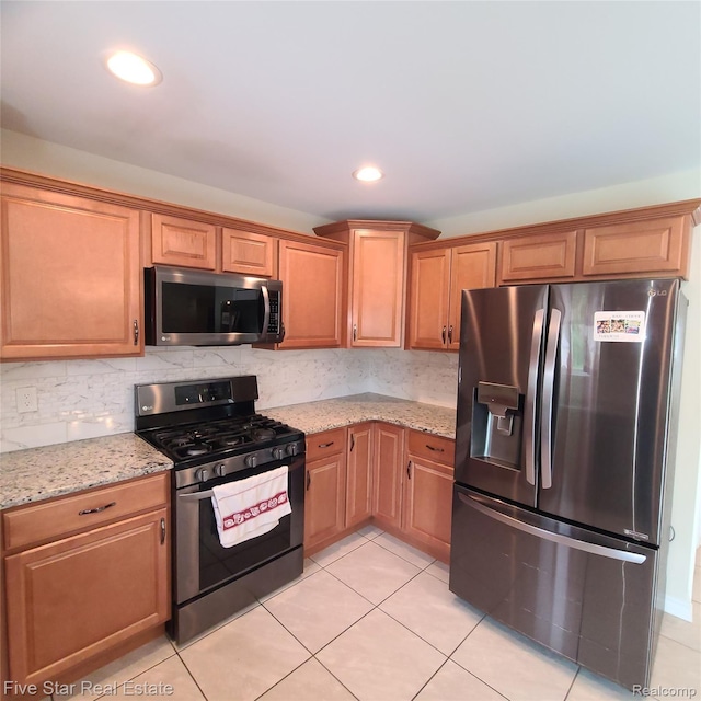 105 Degurse Ave, Marine City, MI 48039 - kitchen featuring appliances with stainless steel finishes, light stone counters, light tile patterned flooring, backsplash, and recessed lighting