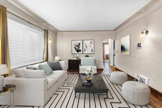 8304 Pinehurst St, Detroit, MI 48204 - living area featuring arched walkways, a textured wall, and wood finished floors