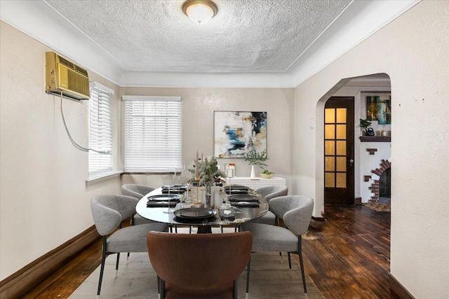 8304 Pinehurst St, Detroit, MI 48204 - dining area with arched walkways, a textured ceiling, wood finished floors, and an AC wall unit