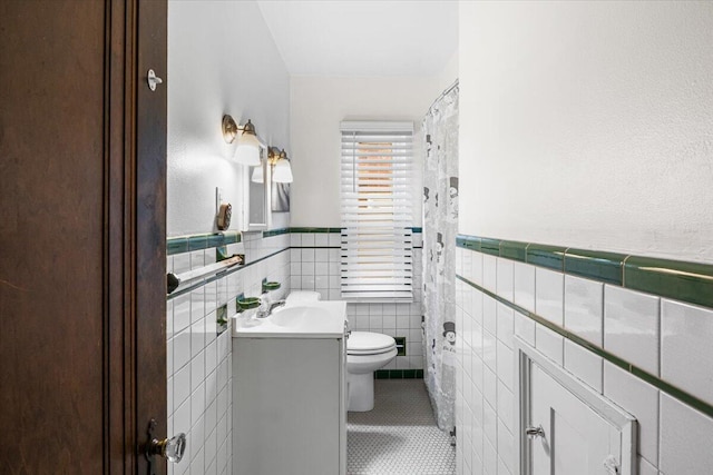 8304 Pinehurst St, Detroit, MI 48204 - bathroom featuring vanity, tile walls, tile patterned flooring, and wainscoting