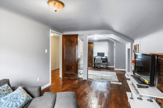 8304 Pinehurst St, Detroit, MI 48204 - living area featuring an office area, wood finished floors, vaulted ceiling, and arched walkways