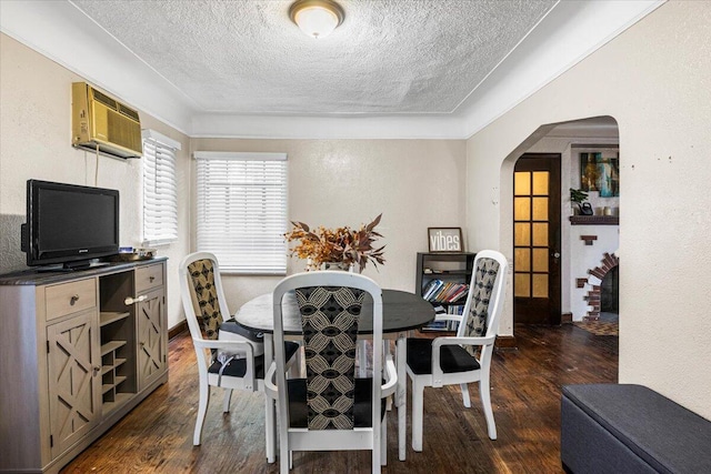 8304 Pinehurst St, Detroit, MI 48204 - dining space featuring arched walkways, a textured ceiling, dark wood-style floors, and a wall mounted air conditioner
