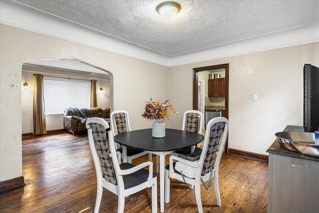 8304 Pinehurst St, Detroit, MI 48204 - dining space featuring a textured ceiling, wood finished floors, and arched walkways