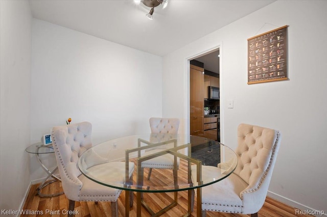 8200 E Jefferson Ave Unit 1802, Detroit, MI 48214 - dining room with baseboards and wood finished floors