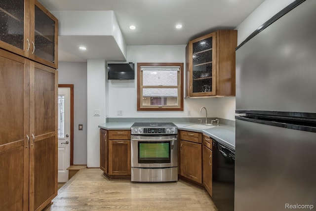 284 W Clarkston Rd, Lake Orion, MI 48362 - kitchen with appliances with stainless steel finishes, light wood-type flooring, brown cabinets, glass insert cabinets, and recessed lighting