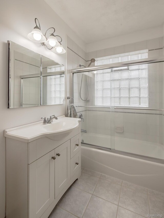 284 W Clarkston Rd, Lake Orion, MI 48362 - bathroom featuring vanity, tile patterned flooring, and shower / bath combination with glass door