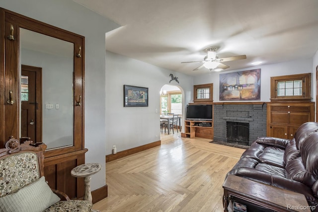 284 W Clarkston Rd, Lake Orion, MI 48362 - living area with ceiling fan, a brick fireplace, and arched walkways
