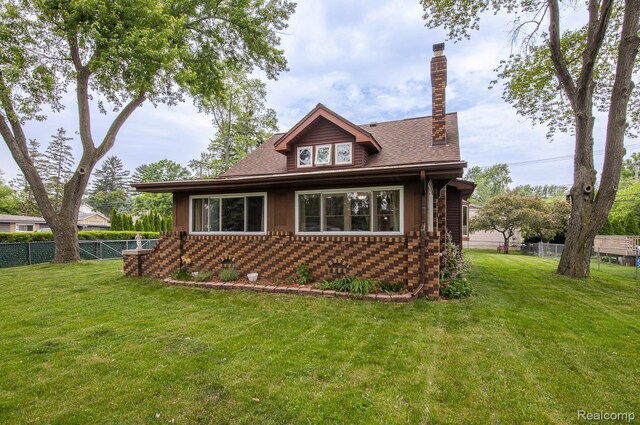 284 W Clarkston Rd, Lake Orion, MI 48362 - view of side of property with a chimney, brick siding, and roof with shingles
