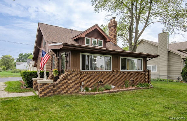 284 W Clarkston Rd, Lake Orion, MI 48362 - bungalow with a front lawn, a chimney, roof with shingles, and brick siding