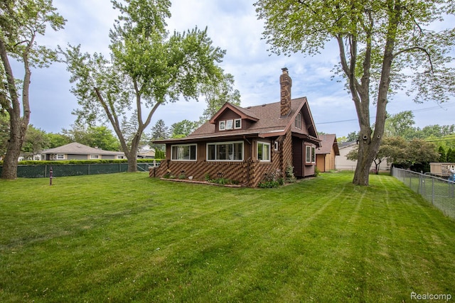 284 W Clarkston Rd, Lake Orion, MI 48362 - back of house with a fenced backyard and a chimney