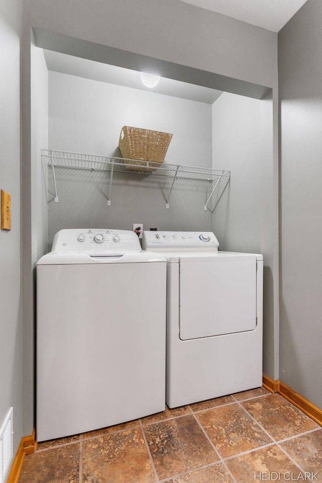 2973 Riley Ridge Rd, Holland, MI 49424 - washroom with washing machine and dryer and stone finish flooring