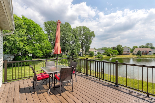 2973 Riley Ridge Rd, Holland, MI 49424 - deck featuring outdoor dining area, a water view, and a yard
