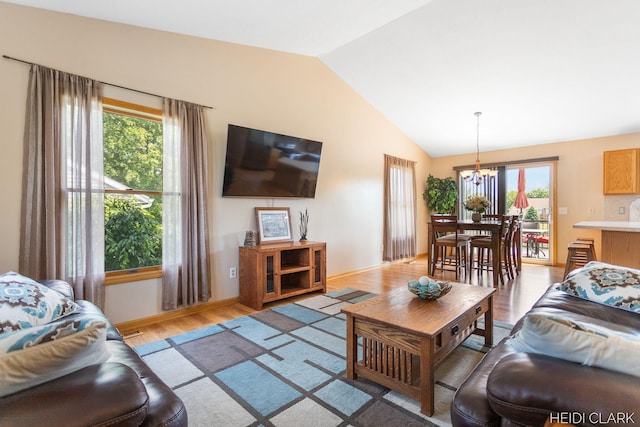 2973 Riley Ridge Rd, Holland, MI 49424 - living room with a chandelier, light wood finished floors, and vaulted ceiling