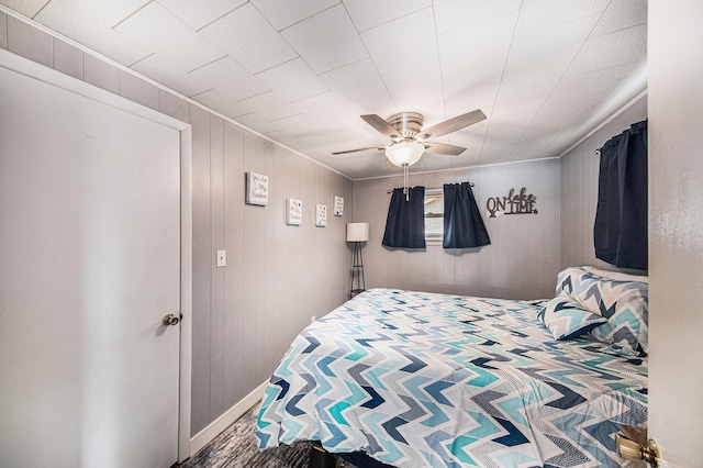 2759 Hemlock Rd, Quincy, MI 49082 - bedroom with ceiling fan and wood walls