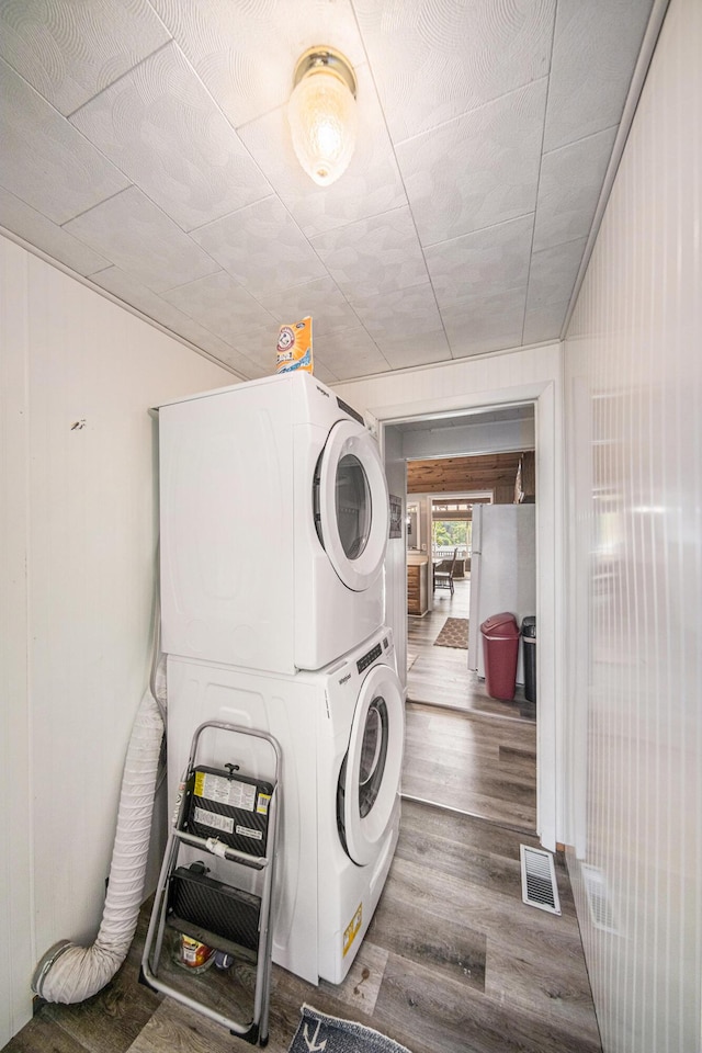 2759 Hemlock Rd, Quincy, MI 49082 - washroom with estacked washer and dryer and wood finished floors