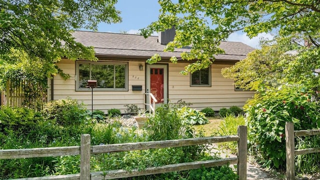 522 Lyon St, South Haven, MI 49090 - view of front of house featuring a chimney and roof with shingles