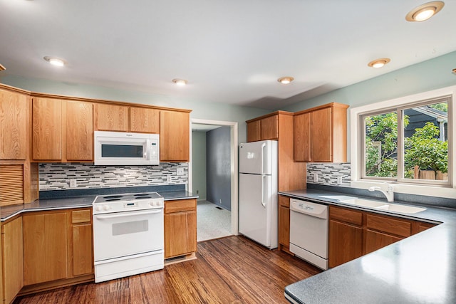 522 Lyon St, South Haven, MI 49090 - kitchen with white appliances, dark wood finished floors, decorative backsplash, dark countertops, and recessed lighting