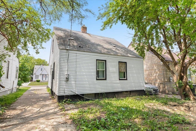 20192 Rogge St, Detroit, MI 48234 - rear view of house with a shingled roof and a chimney