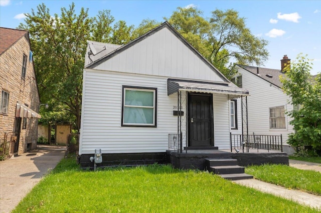 20192 Rogge St, Detroit, MI 48234 - view of front facade with board and batten siding and a front yard