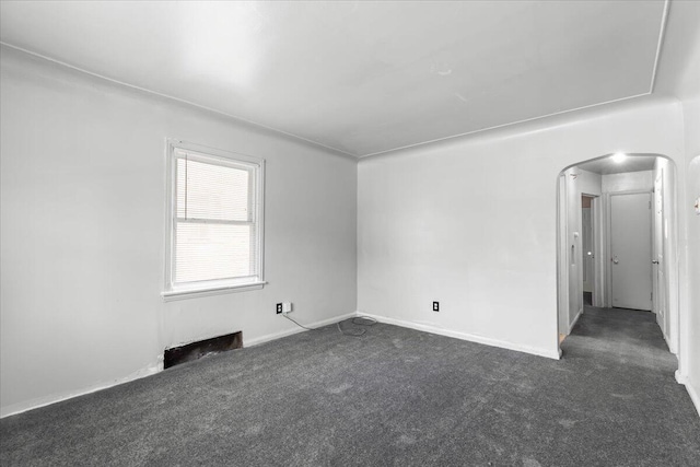 20192 Rogge St, Detroit, MI 48234 - empty room with arched walkways and dark carpet