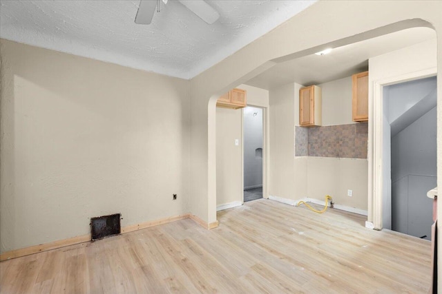 20192 Rogge St, Detroit, MI 48234 - empty room featuring light wood-type flooring, a ceiling fan, and arched walkways