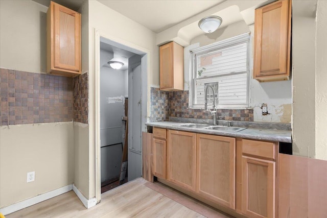 20192 Rogge St, Detroit, MI 48234 - kitchen with light wood-style flooring, decorative backsplash, light brown cabinets, and light countertops