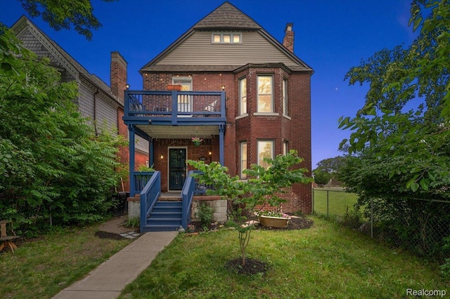 1769 W Warren Ave, Detroit, MI 48208 - view of front of property featuring a balcony, brick siding, a chimney, and covered porch