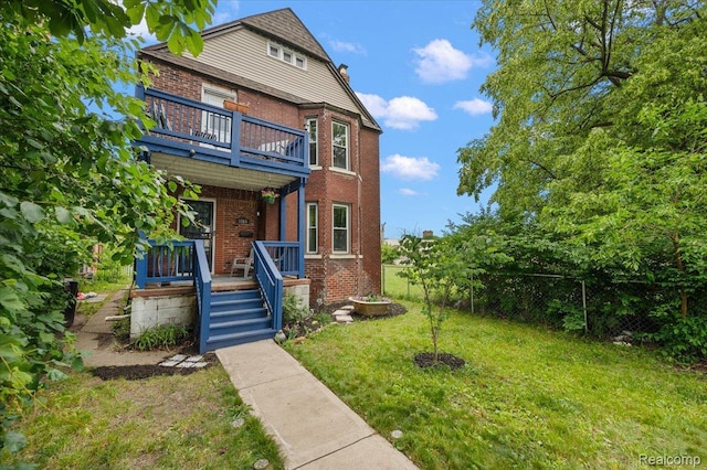 1769 W Warren Ave, Detroit, MI 48208 - view of front facade featuring brick siding, a balcony, and covered porch