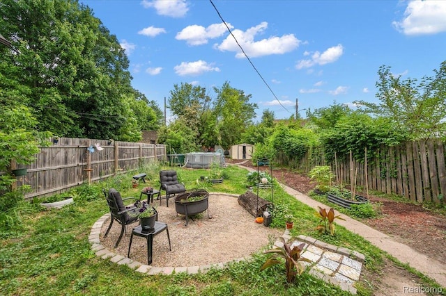 1769 W Warren Ave, Detroit, MI 48208 - fenced backyard with a fire pit and a shed