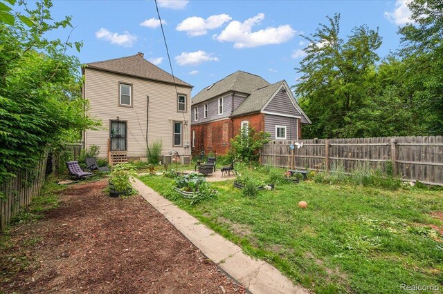 1769 W Warren Ave, Detroit, MI 48208 - back of property with a fenced backyard and a patio