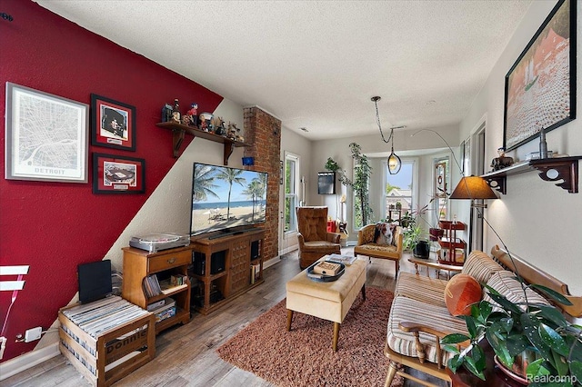 1769 W Warren Ave, Detroit, MI 48208 - living area featuring light wood-style floors and a textured ceiling