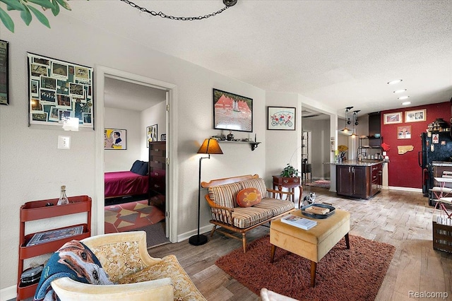 1769 W Warren Ave, Detroit, MI 48208 - living room with light wood finished floors and a textured ceiling
