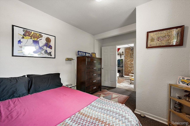 1769 W Warren Ave, Detroit, MI 48208 - bedroom with dark carpet and a textured wall