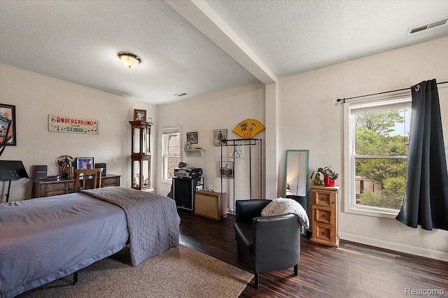 1769 W Warren Ave, Detroit, MI 48208 - bedroom featuring dark wood-type flooring and a textured ceiling