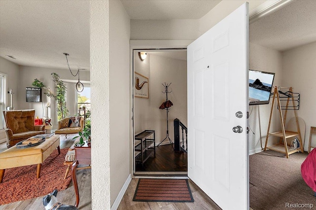 1769 W Warren Ave, Detroit, MI 48208 - hallway with a textured ceiling and wood finished floors