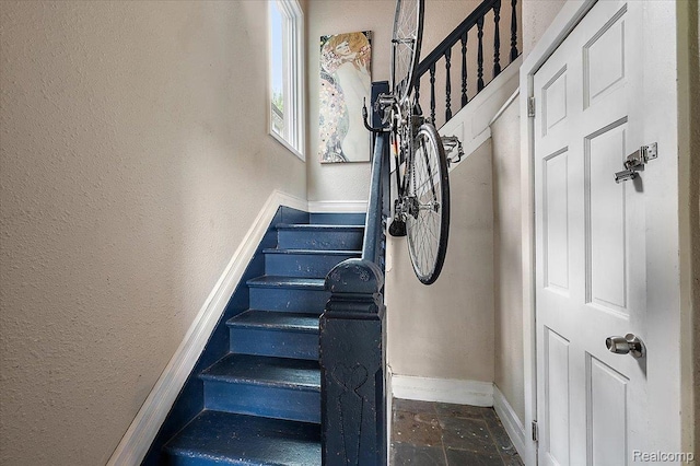 1769 W Warren Ave, Detroit, MI 48208 - staircase with a textured wall and stone tile floors