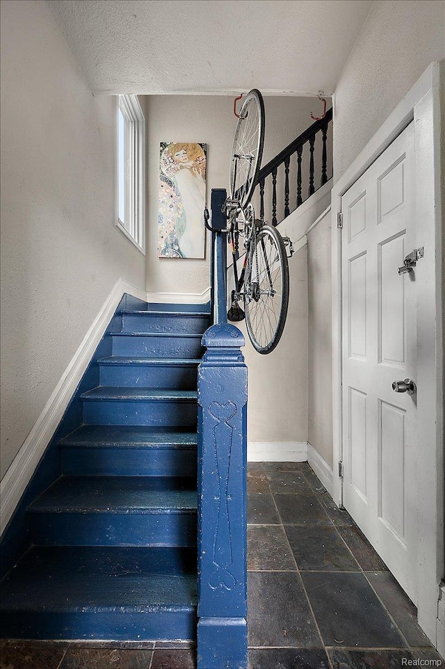 1769 W Warren Ave, Detroit, MI 48208 - staircase with stone tile floors and a textured ceiling