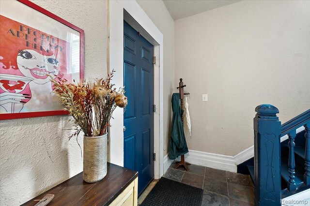 1769 W Warren Ave, Detroit, MI 48208 - entryway with baseboards and stone finish flooring
