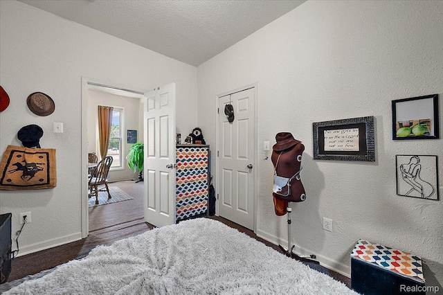 1769 W Warren Ave, Detroit, MI 48208 - bedroom with a textured wall, wood finished floors, and vaulted ceiling