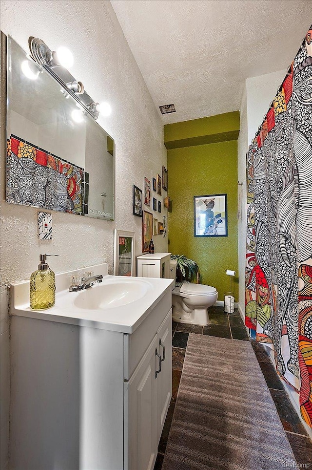 1769 W Warren Ave, Detroit, MI 48208 - bathroom with a textured wall, vanity, and a textured ceiling